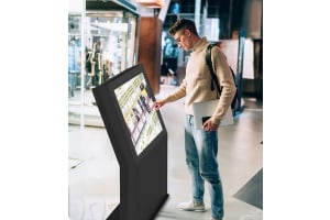 immersive audio visual blog post - image shows a person using a touch screen map in a retail environment